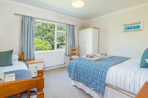 a bedroom with two beds and a window at Glandraeth in Newport