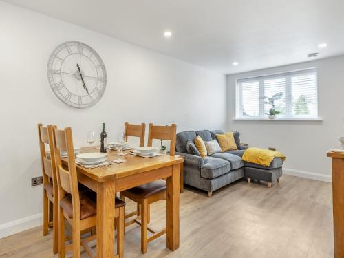a dining room with a table and a couch at Fallow's Holt in Buildwas