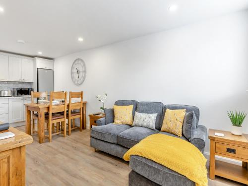 a living room with a couch and a table at Fallow's Holt in Buildwas