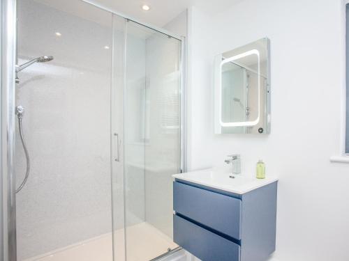 a bathroom with a shower and a sink and a mirror at Primrose-Uk34614 in Nether Stowey