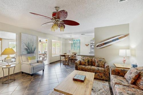 a living room with a couch and a ceiling fan at Golden Palms in Laguna Vista
