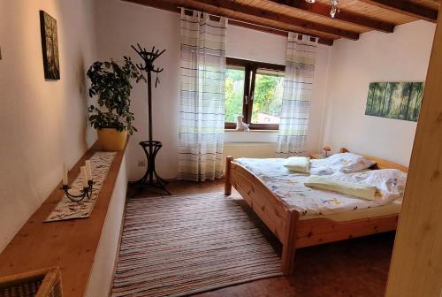 a bedroom with a bed and a window at Haus Alpaka in Bad König