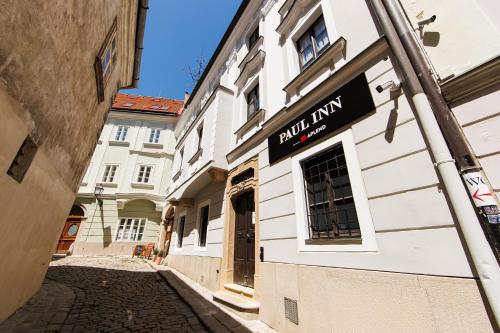 a building with a sign on the side of a street at APLEND CITY Paul Inn in Bratislava