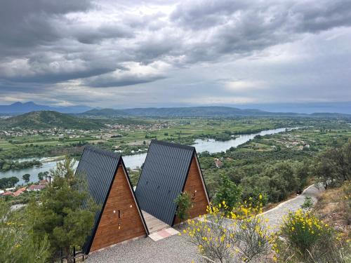 a house on top of a hill with a river at Doel House Zues - Hot Tub Villa & Scenic View in Shkodër