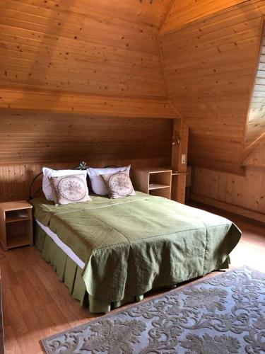 a bedroom with a bed in a wooden room at Bystrytsya Lux in Ivano-Frankivsk