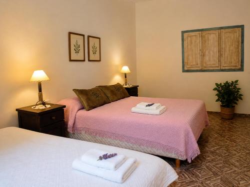 two beds in a hotel room with towels at El Indio - Casa de Campo con Piscina y Parrilla in Villa del Salvador