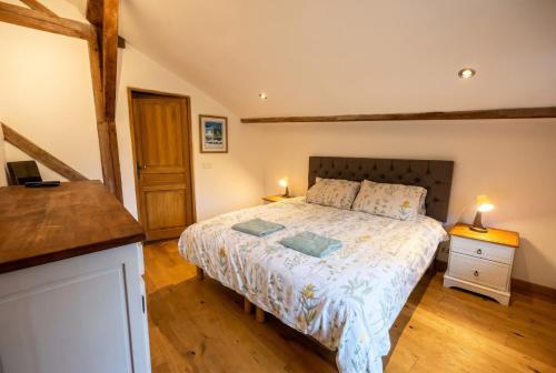 a bedroom with a bed with two lamps on it at Top Floor Chalet Apartment in Saint-Jean-d'Aulps, Balcony in Saint-Jean-d'Aulps