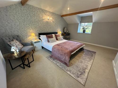 a bedroom with a large bed and a couch at The Little Vicarage in Highbridge