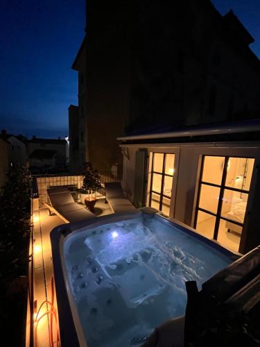 a hot tub on a balcony at night at Stone House Orsera II in Vrsar