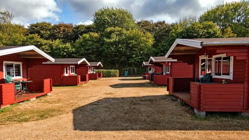 a row of red cabins in a row at Morsø Camping in Nykøbing Mors