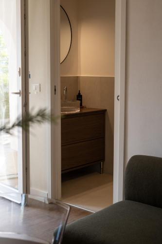 a bathroom with a mirror and a dresser in a room at Rosmaris - Villa nel verde in Francavilla al Mare
