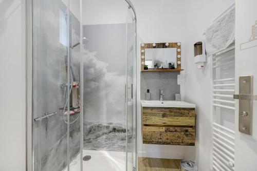 a bathroom with a shower and a sink at Comme à la maison in Ducey