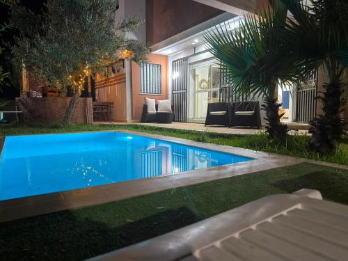 a swimming pool in the middle of a yard at night at Dar Julia in Sousse