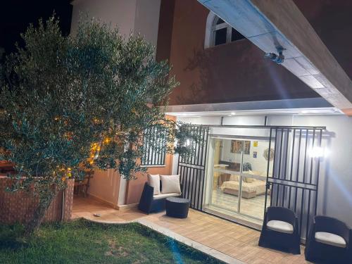 a house with a patio with a couch and a tree at Dar Julia in Sousse