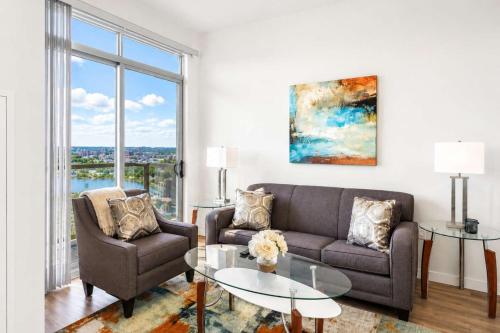 a living room with a couch and two chairs and a table at Luxury Apartment In Harbor Point in Stamford