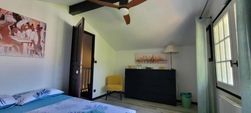 a bedroom with a bed and a dresser and a window at Chambres cosy au hameau de St Pierre in Saint-Georges-de-Commiers