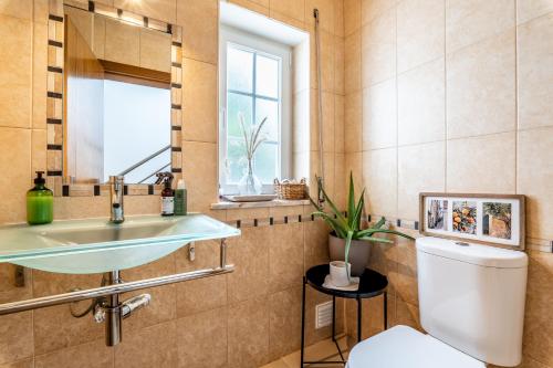 a bathroom with a sink and a toilet at Casa Leonor, stunning 3 bedroom villa in Carvoeiro in Praia do Carvoeiro