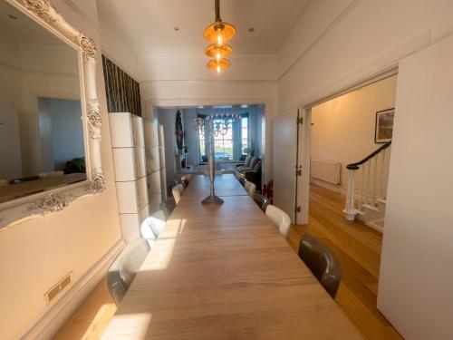 a long table in a living room with a long table at Hastings House 9-Bedroom Holiday House in Hastings