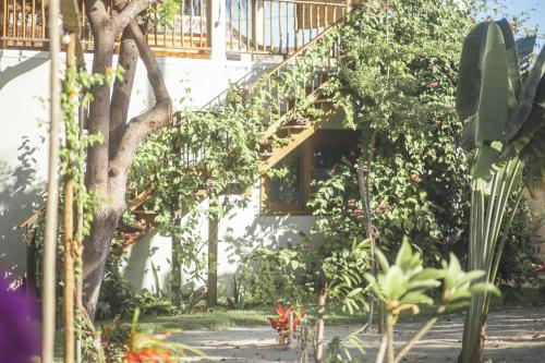 a house with a balcony and a tree at Vila hangloose pôr do sol in Acaraú