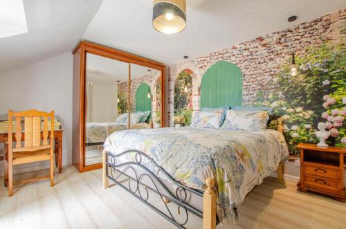 a bedroom with a bed and a brick wall at La gentilhommière in Villemorien