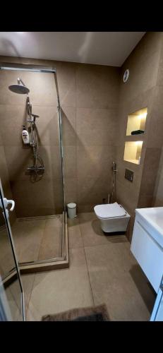 a bathroom with a shower and a toilet and a sink at CIty view apartment in Gotse Delchev