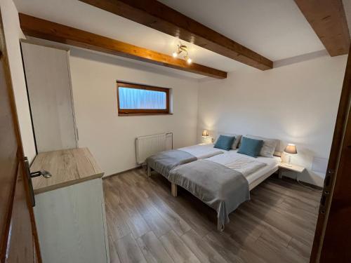 a bedroom with a bed with blue pillows at Privat Beata in Hrabušice