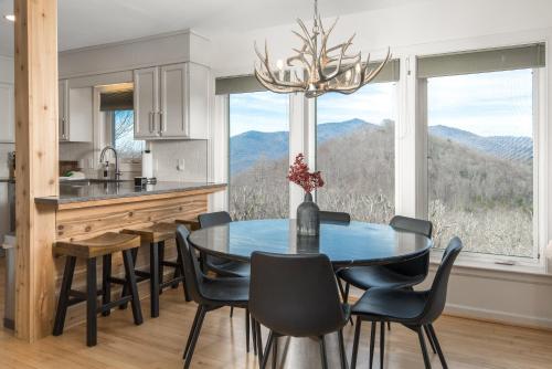 a kitchen with a table and chairs and a large window at Misty Ridge Retreat in Blowing Rock