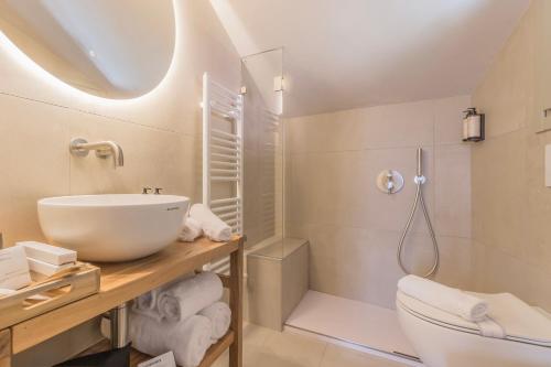 a bathroom with a sink and a toilet and a shower at La Corte del Lario - Contrada del Duca in Varenna