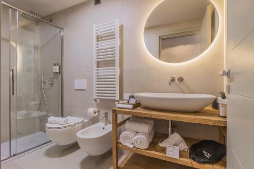 a bathroom with a sink and a toilet and a shower at La Corte Del Lario - San Giorgio in Varenna