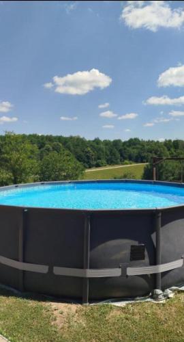 a large swimming pool with a blue water at Slavotova hiža in Mračin