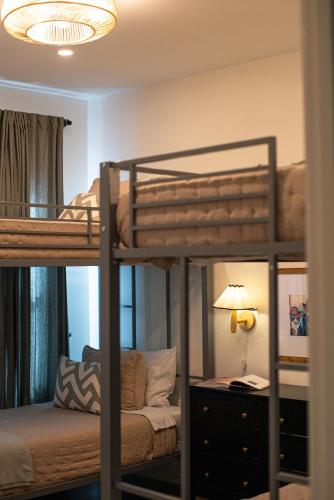a bedroom with two bunk beds and a lamp at Orion B, Vaulted Ceilings, Pool, Bunk Room in Port Isabel