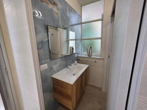 a bathroom with a sink and a mirror at Sicilia Mount&Sea in Mascali