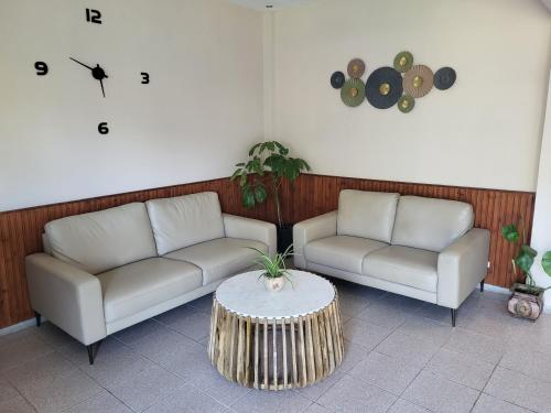 a living room with two couches and a coffee table at Vourvourou Hotel in Vourvourou