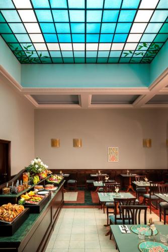 a restaurant with a buffet of food on tables at Hotel Diocleziano in Rome