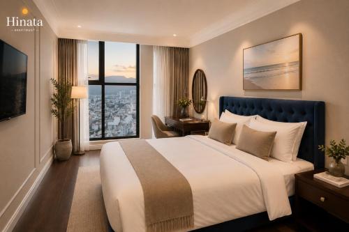 a bedroom with a large bed and a large window at Luxury Apartment - Rooftop Swimming Pool - Beach Front - Hinata Apartment in Danang