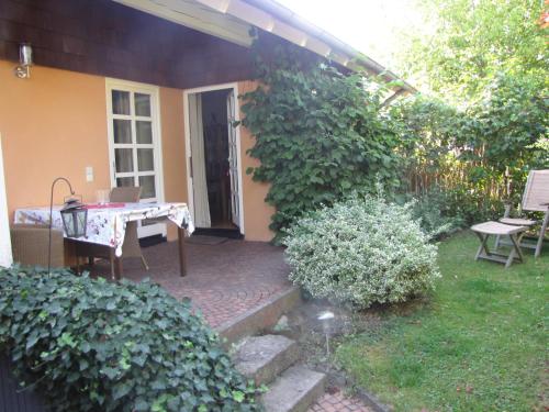 a patio with a table and chairs in a yard at Ferienwohnung Am Odenwaldlimes in Vielbrunn