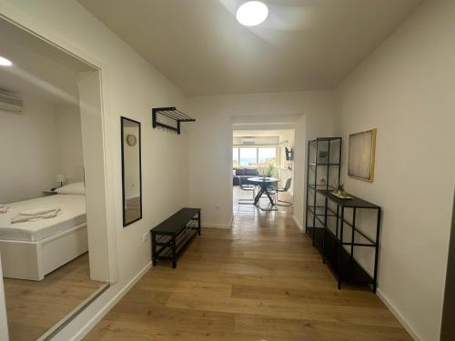 a hallway with a bed and a table in a room at Apartmani Paula in Makarska