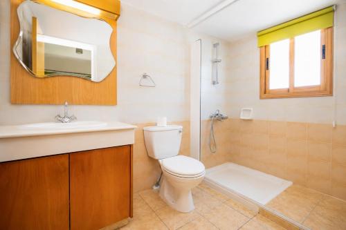 a bathroom with a toilet and a sink and a shower at Argaka Sunset Villa in Argaka