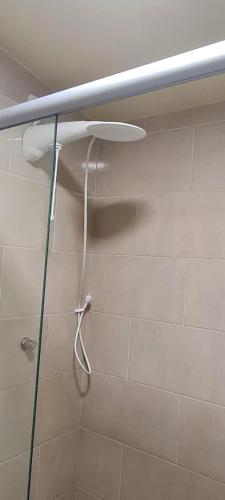 a shower with a shower head in a bathroom at Cabana Refúgio do Hobbit-Gramado @refugiodohobbit in Gramado