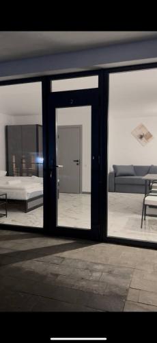 a view of a living room through a glass door at Zveniv Resort in Oryavchyk