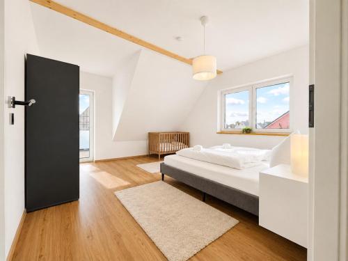 a bedroom with a bed and a large window at Dill Apartment Pleinfeld am Brombachsee III in Pleinfeld