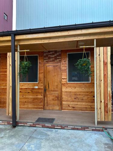 a wooden building with two windows and a door at Chaki 2 in Ureki
