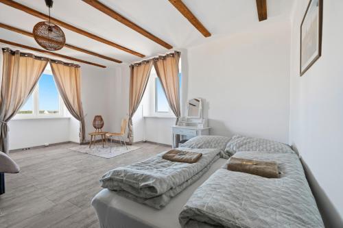 a bedroom with two beds and a desk at Appartement im Schloßhof in Rechnitz
