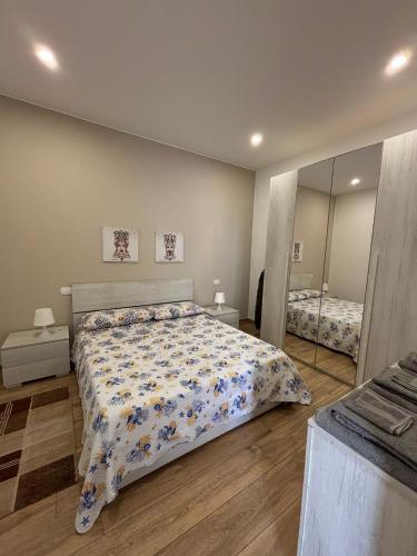 a bedroom with a bed and a large mirror at Caruso'S House1 in Syracuse