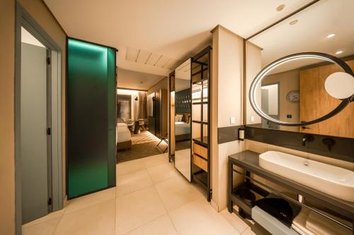 a bathroom with a sink and a mirror at The NINE Lifestyle Experience in Tunis