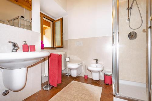 a bathroom with a sink and two toilets at Happy Guest Apartments - Lake And Passion in Riva di Solto