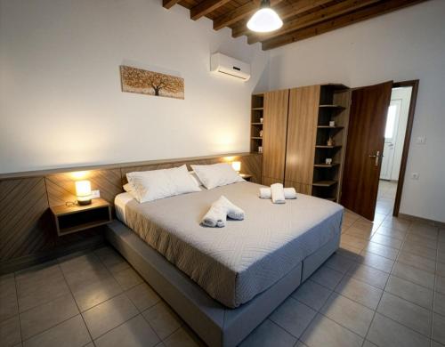 a bedroom with a bed with towels on it at Casa Thea in Archangelos