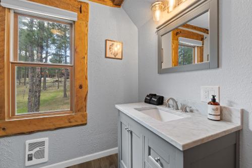 a bathroom with a sink and a window at Tatanka Hideaway Hot Tub Pool Table Massive Space in Custer