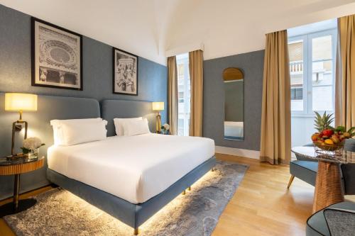 a bedroom with a large white bed in a room at Tivoli Palazzo 1880 Lecce Hotel in Lecce