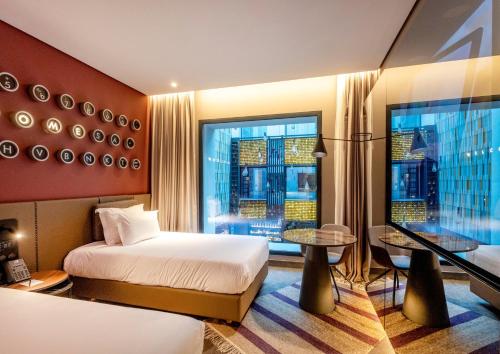 a hotel room with two beds and a window at The NINE Lifestyle Experience in Tunis